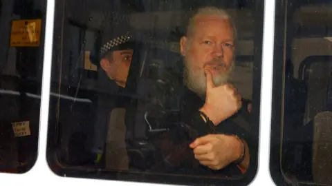 Reuters Julian Assange pictured in a police van