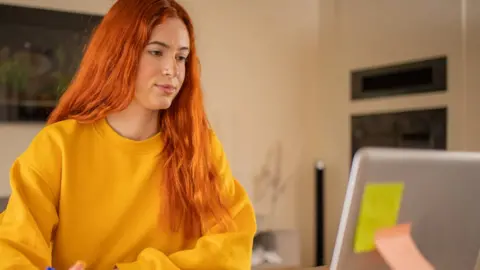 A student looking at her computer