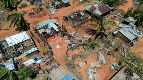 A drone view of destroyed houses and buildings following cyclone Chido in Pemba, Mozambique on 18 December