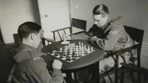 Getty Images Two soldiers playing a game of chess at the Beaver Club