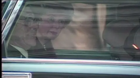 A tearful Margaret Thatcher in the back of a car as she leaves No 10 on 28 November 1990