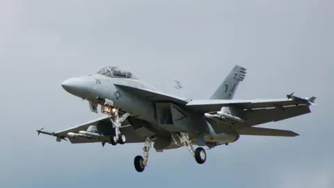 A US Navy Boeing F/A-18 Hornet fighter jet coming in to land