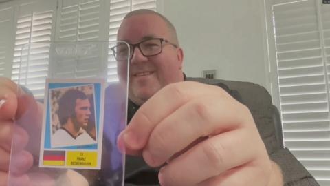 Stephen Bunting holds Franz Beckenbauer sticker