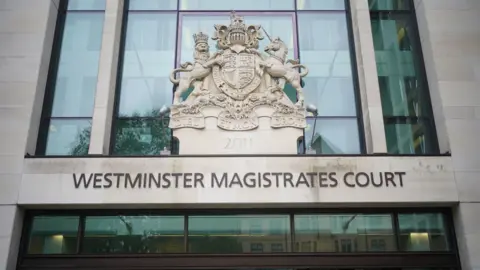 PA Media A general view of the entrance to Westminster Magistrates Court. The name of the court is written on the front of the building above an entrance. The HM Courts and Tribunal Service embled rests above the court name.