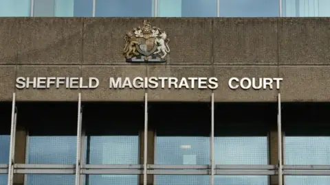 BBC The exterior of Sheffield Magistrates' Court, with the name of the court in white writing. Above it is a crest, with a row of windows beneath the sign.