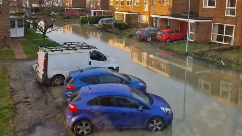 Vehicles parked in flooded street