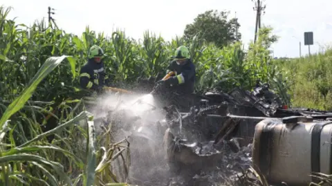 Ukraine Emergencies Ministry Rescuers cut victims from the wreckage of one of the vehicles