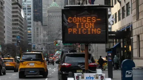 A sign showing the words "congestion pricing" is seen in New York City on 3 January 2025.