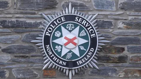 The PSNI badge upon a stone wall