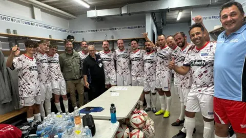 Rugby For Heroes & B3 Creative  Group of men in changing room in matching football kit