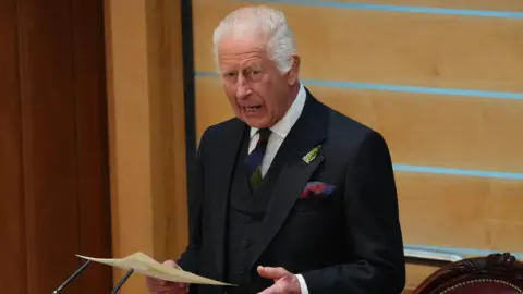 King Charles III addressing the Holyrood Chamber during a visit to the Scottish Parliament in Edinburgh to mark its 25th anniversary.