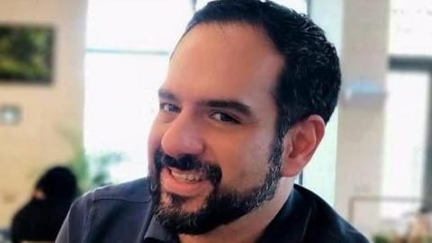 Headshot of Manuel Guerrero Aviña, who has dark, short-cropped hair and a beard, wearing a dark navy shirt