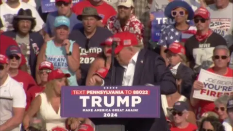 Donald Trump ducks after loud bangs heard at a rally in Pennsylvania