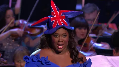 Angel Blue performs at the Last Night of the Proms, wearing a Union Jack jester's hat