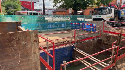 Large hole being repaired in County Road by football stadium