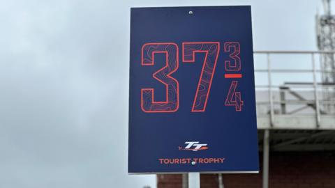 37-and-three-quater mile milestone sign at the Grandstand