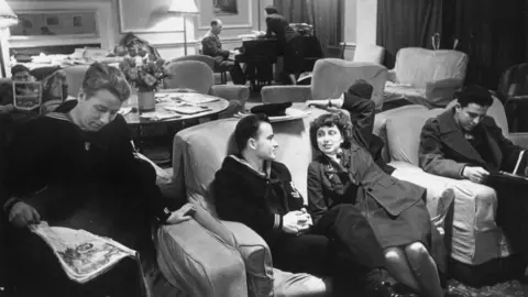 Getty Images 27th January 1945: Members of the forces talking and listening to classical records as they relax in Rainbow Corner the American Service Men's club in Piccadilly, London which is open to all members of the Allied forces. Original Publication: Picture Post - 1887 - Inside Rainbow Corner - pub. 1945 (Photo by Kurt Hutton/Picture Post/Hulton Archive/Getty Images)