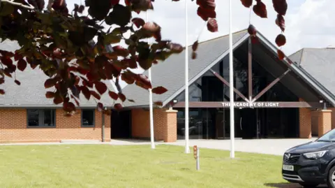 LDRS  The outside of Sunderland's training facility - a one story building with a sign on the door saying Academy of Light 