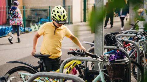 Welsh Government Pupil arrives at Howardian School, Cardiff on his bike.  