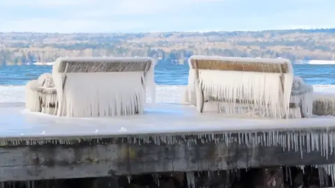 Benches are covered in ice.