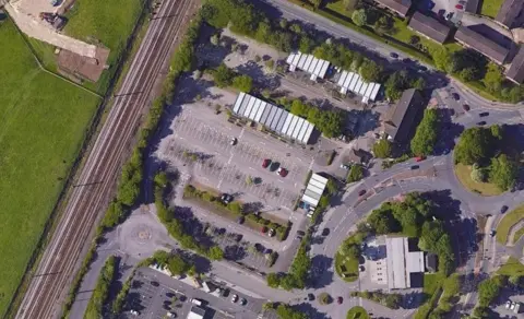 An aerial picture of the site showing the units it is housed in and a car park.