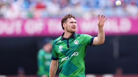 Ireland fast bowler Josh Little catches the ball 