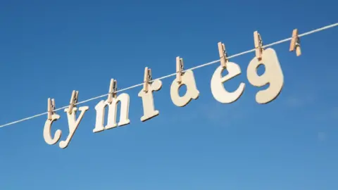 Cymraeg spelled out in letters hanging by pegs from a washing line