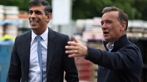 Defeated Vale of Glamorgan candidate Alun Cairns pointing something out to Prime Minister Rishi Sunak during the election campaign