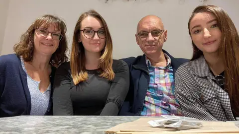 Sturman family Sara-Jane, Megan, Paul and Lizzie Sturman sat in front of a table