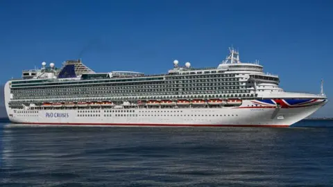 Getty Images Ventura - a large cruise ship with a union flag painted on the side. It is at sea.