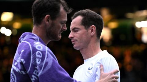 A tearful Andy Murray is consoled by Jamie Murray at Wimbledon