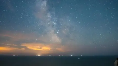 A shot of stars above the sea taken on Beachy Head, East Sussex. 