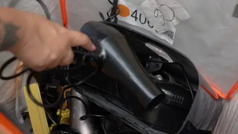 A broken hairdryer being recycled