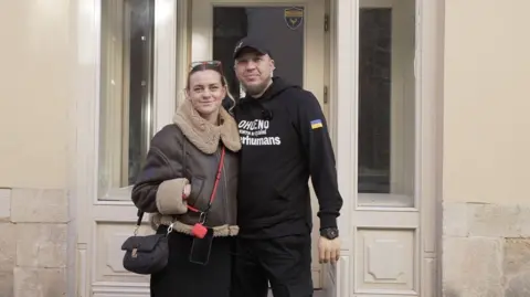 Chad Andrii-Mykhailo Serhiy Petchenko and wife Anna outside their new cafe