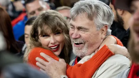 Taylor Swift hugs Ed Kielce after the AFC Championship NFL football game between the Kansas City Chiefs and Baltimore Ravens at M&T Bank Stadium on January 28, 2024 in Baltimore, Maryland