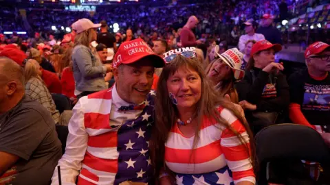 A man and a woman dressed in USA flag colours at the Madison Square Gardens Trump rally 