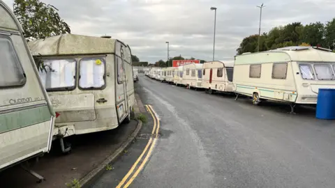 The caravans in Bristol lined up on either side of the road where Home Office officials raided last week