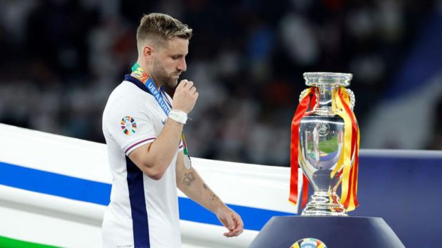 Luke Shaw of England passing dejected the European Championship Trophy during the EURO match between Spain v England at the Olympiastadium on July 14, 2024