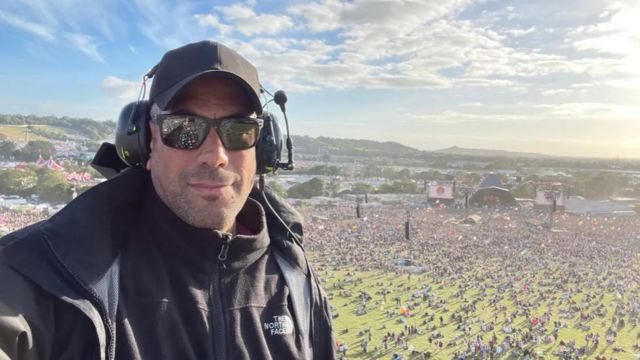 Gohil films the Pyramid Stage from a crane above the crowds at Worthy Farm