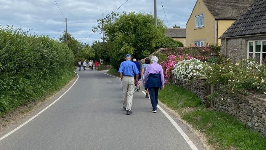 Several people walking down a road