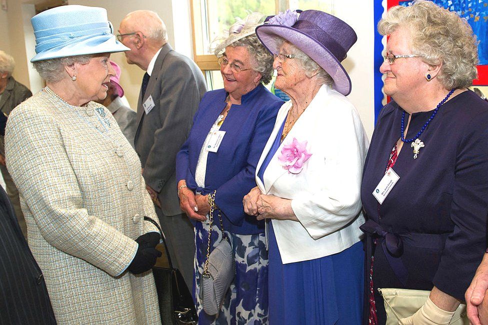 Queen Elizabeth II chats with parents bereaved by the 1966 Aberfan disaster, Marjorie Collins, Elaine Morgan and Jean Gough, during her visit to officially open Ynysowen Community Primary School on April 27, 2012