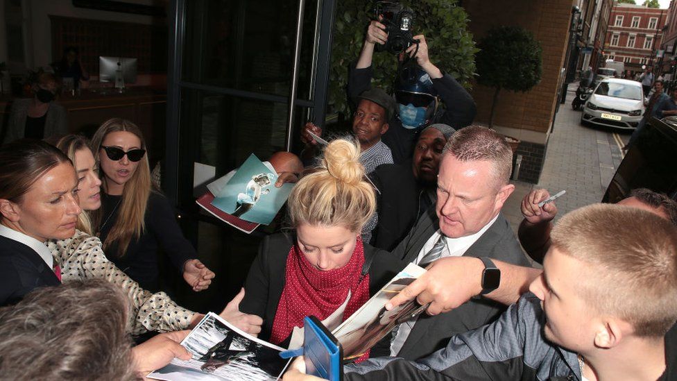 Amber Heard is mobbed by fans upon arrival at her hotel after an appearance at the Royal Courts of Justice, Strand on July 24, 2020 in London, England