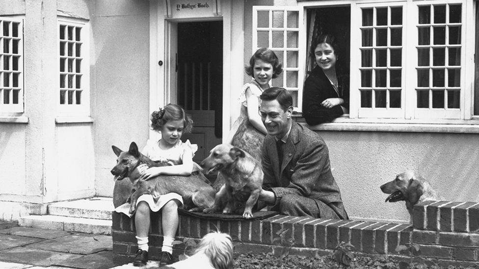 Childhood influence: King George VI and Queen Elizabeth with Margaret (left) and Elizabeth at Y Bwthyn Bach (small cottage) in the grounds of Windsor Castle, presented to the princesses by the people of Wales in 1931
