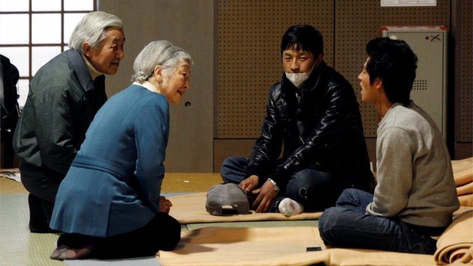 Japan's Emperor Akihito (L) and Empress Michiko (2nd L) talk with evacuees from the March 11 earthquake and tsunami