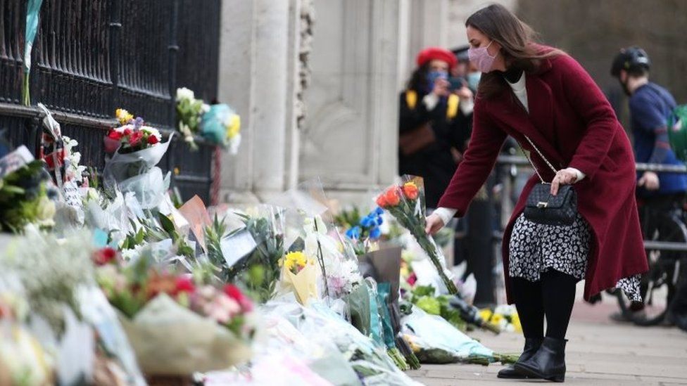 Floral tributes are left outside Buckingham Palace