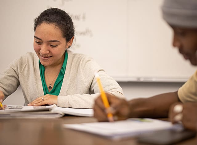 two people working on class work