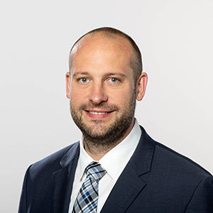 Headshot of Prof. Dr. Sebastian J. Goerg , a middle age man smiling on a simple white  background.