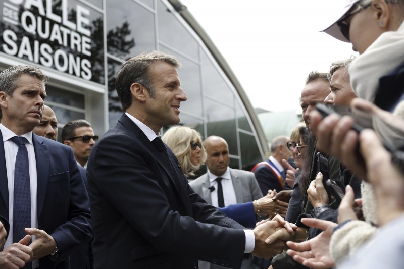 2024年7月7日，完成投票的法國總統馬克宏與支持者交談。（美聯社）