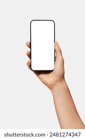 Close up of woman hand holding modern smart phone mockup. New modern black frameless smartphone mockup with blank white screen. Isolated on white background high quality studio shot Modern smart