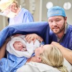 Shot of a beautiful young couple welcoming their newly born baby girl in the hospital